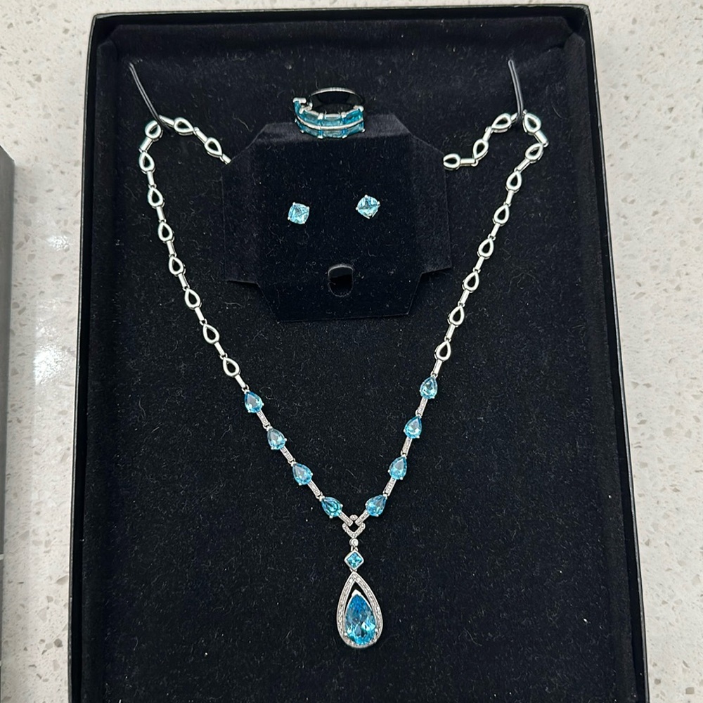 Sterling silver blue topaz necklace and earrings. Drop pendant cushion cut studs